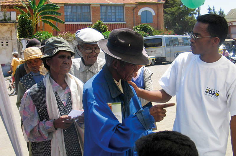 5706518559_d1debdf8d6_b A community eye health worker answering questions from elderly patients about cataract surgery. MADAGASCAR. © Henry Nkumbe