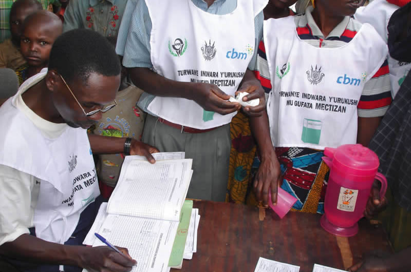Recording-information Volunteers’ commitment to record keeping has been crucial to the success of the mectizan® Donation Program. BURUNDI © Adrian Hopkins