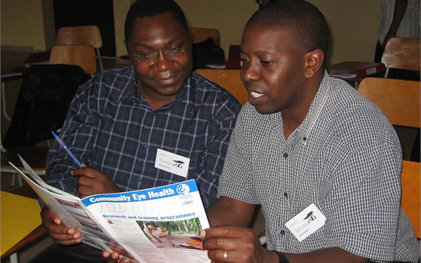 reading-the-journal Two eye care professionals read the journal together at a training workshop. TANZANIA © Clare Gilbert.